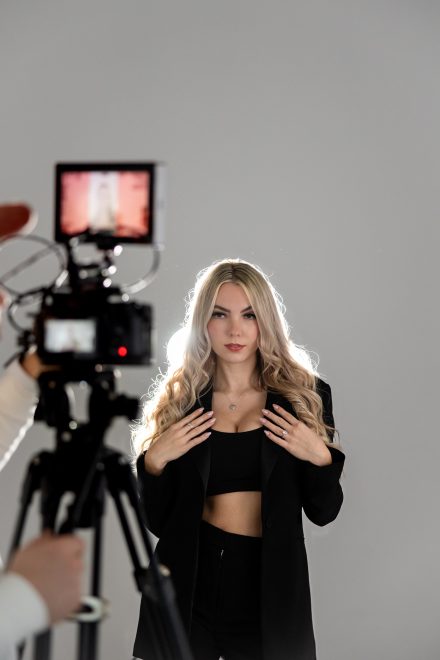 Soft, relaxed headshot of a woman in a light-filled studio in Vancouver, with a neutral background emphasizing her brand presence.