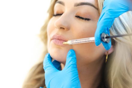 Female practitioner performing a rejuvenating treatment in a modern Vancouver clinic, focusing on enhancing mature skin.