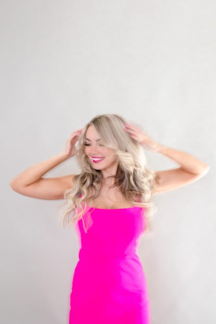 Female entrepreneur laughing during a relaxed branding session in a bright Vancouver studio, capturing her genuine and vibrant energy.