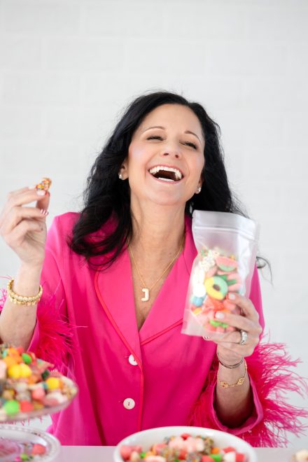 Female entrepreneur laughing during a relaxed branding session in a bright Vancouver studio, capturing her genuine and vibrant energy.