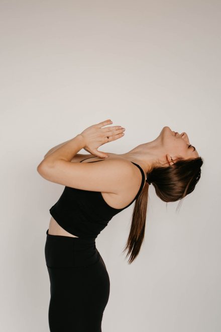 Female yogi posing gracefully in a modern Vancouver studio, surrounded by calming neutral tones.