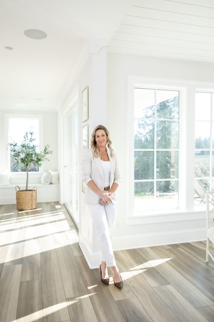 Candid portrait of a professional woman with natural light streaming in, captured in a creative workspace in Fraser Valley.