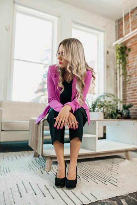 Confident female entrepreneur smiling warmly in a bright Vancouver studio, showcasing her vibrant and approachable brand personality.