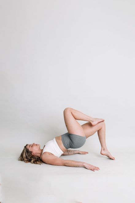 Female yogi posing gracefully in a modern Vancouver studio, surrounded by calming neutral tones.