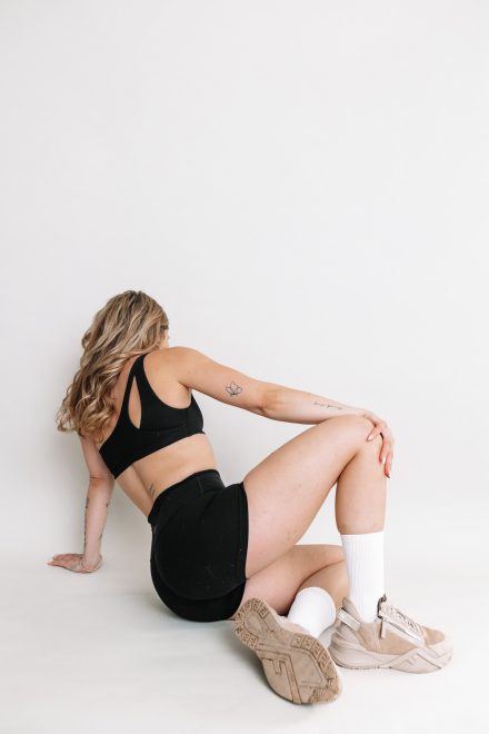 Female yogi posing gracefully in a modern Vancouver studio, surrounded by calming neutral tones.