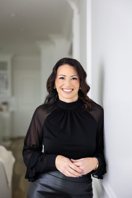 Candid portrait of a professional woman with natural light streaming in, captured in a creative workspace in Fraser Valley.