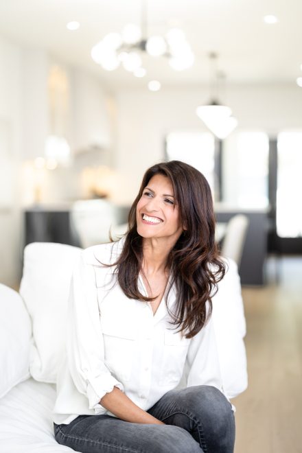 Female entrepreneur laughing during a relaxed branding session in a bright home studio in Langley.