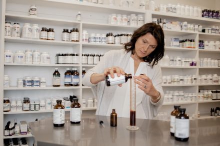 Naturopath standing confidently in a modern treatment room in Vancouver, emphasizing expertise and holistic health