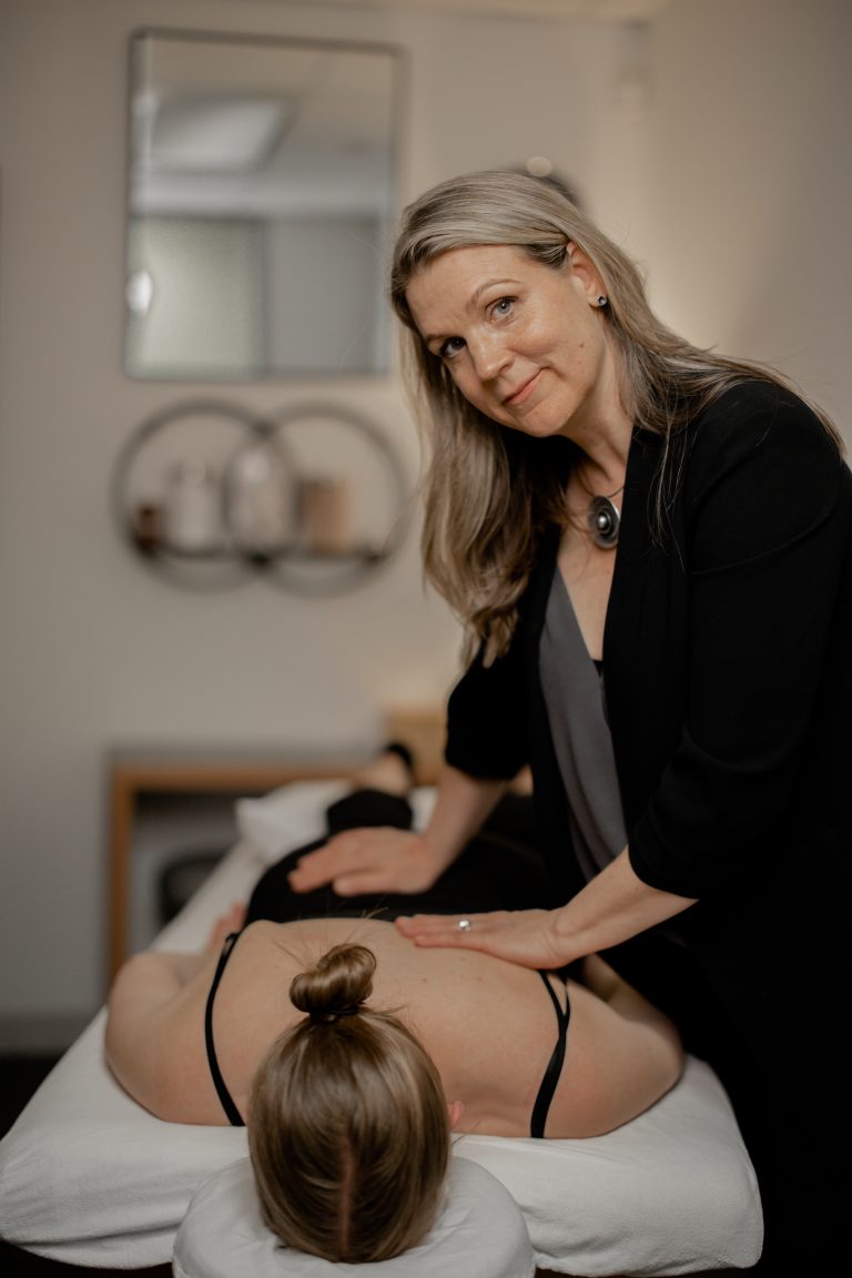 Naturopath standing confidently in a modern treatment room in Vancouver, emphasizing expertise and holistic health