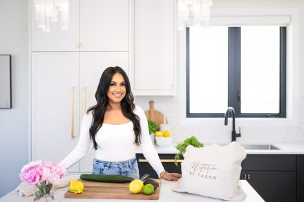 Confident dietitian standing in a well-lit kitchen in Langley, ready to guide clients on their wellness journey.