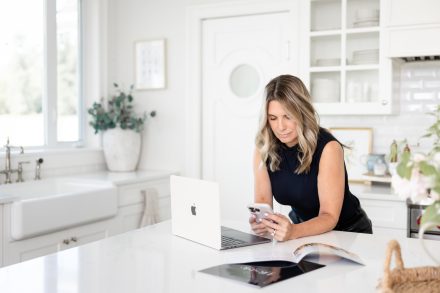 Relaxed and engaging work photo of a realtor in a sunlit kitchen workspace in Fraser Valley, emphasizing authenticity.