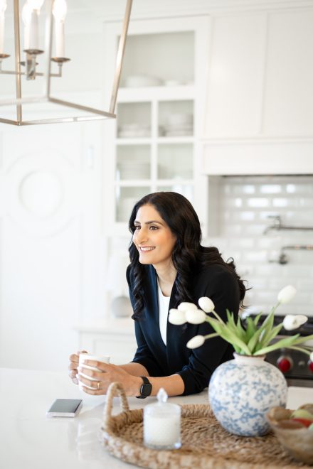 Candid portrait of a professional woman with natural light streaming in, captured in a creative workspace in Fraser Valley.