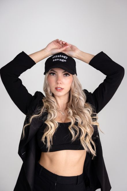 CEO showcasing her business branding merchandise while capturing a headshot