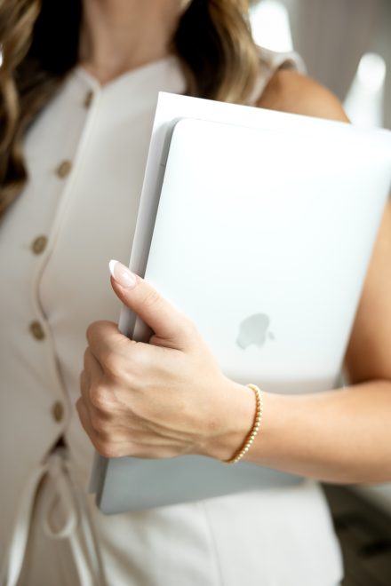 Professional realtor sitting in a minimalist living room setting in a Langley residential listing