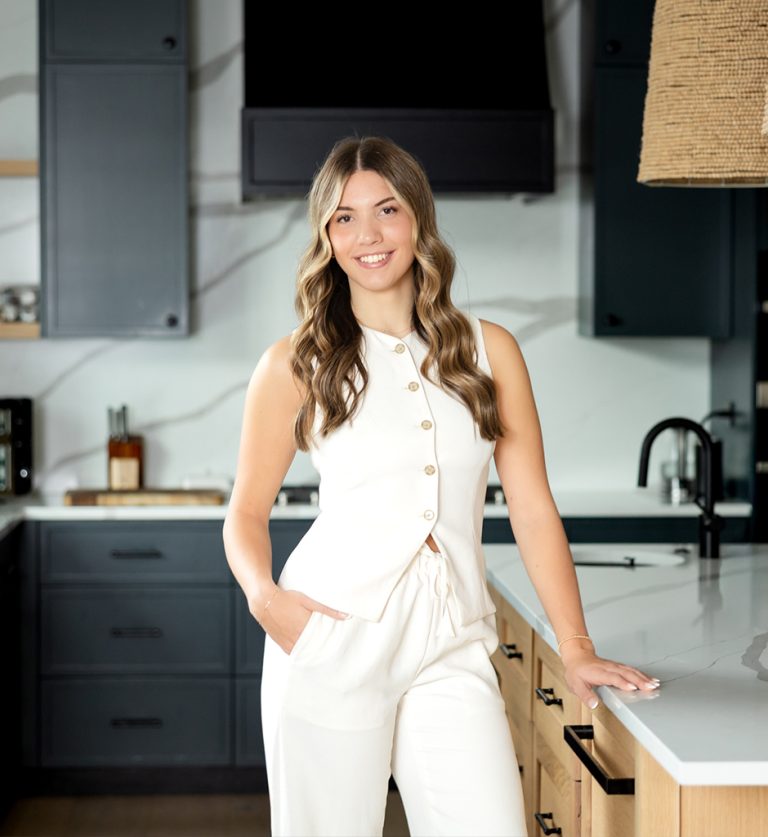 Professional headshot of a female realtor in Langley, BC, smiling in business attire against a blurred office background