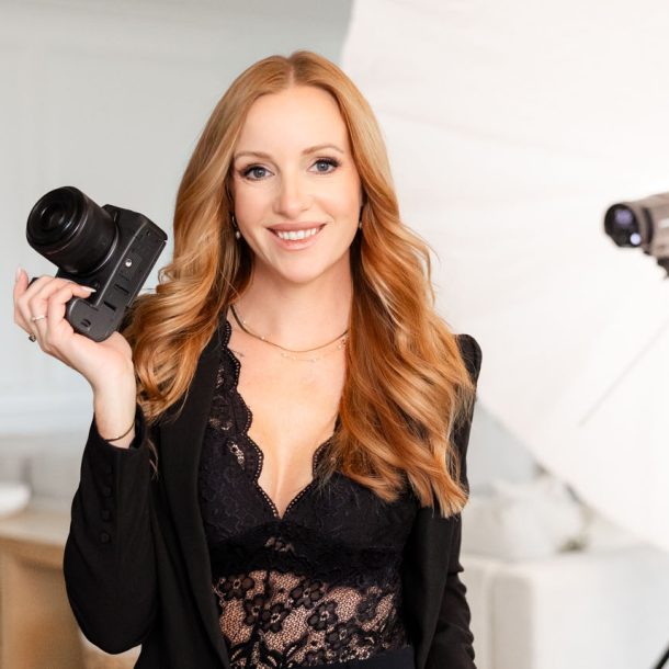 Kate Paterson self portrait holding a camera in studio