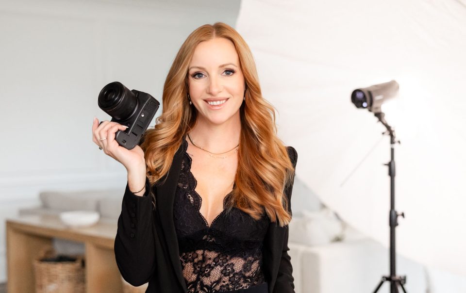 Kate Paterson self portrait holding a camera in studio