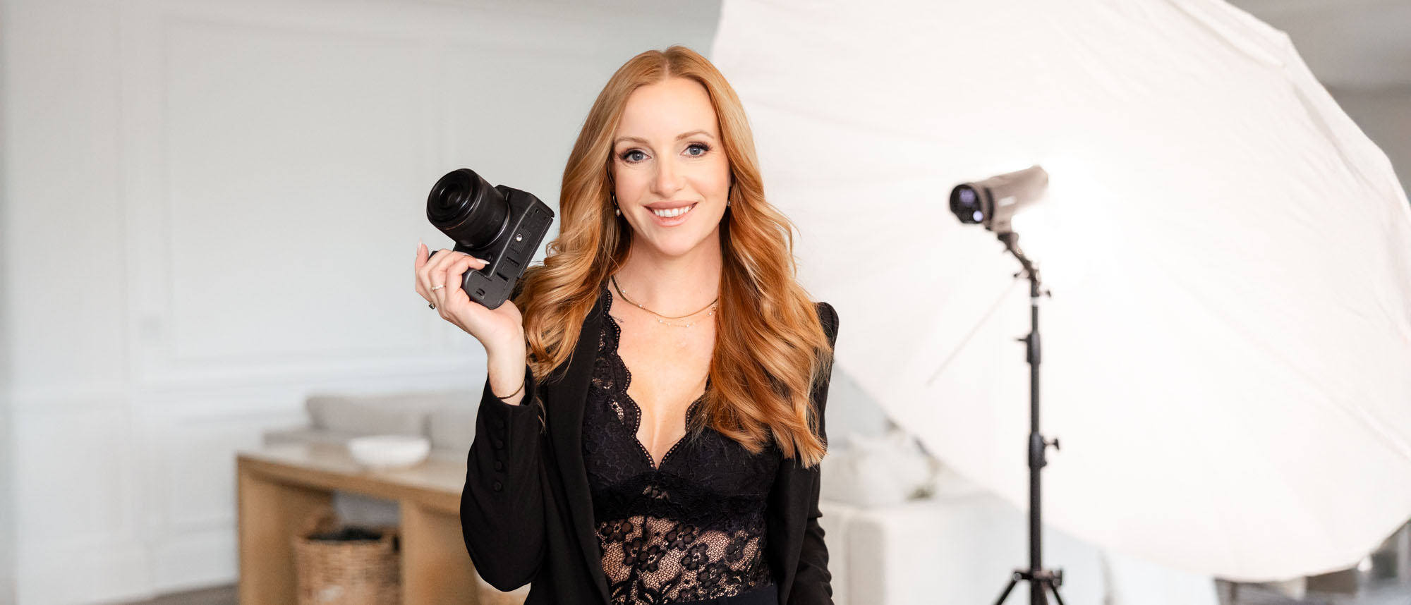 Kate Paterson self portrait holding a camera in studio